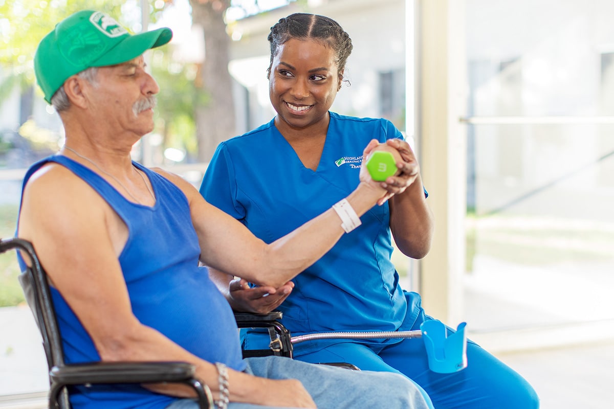 Therapist helping resident in the gym