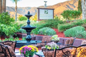 Highland Palms sign outside with fountain