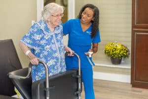 Resident smiling with rehab therapist