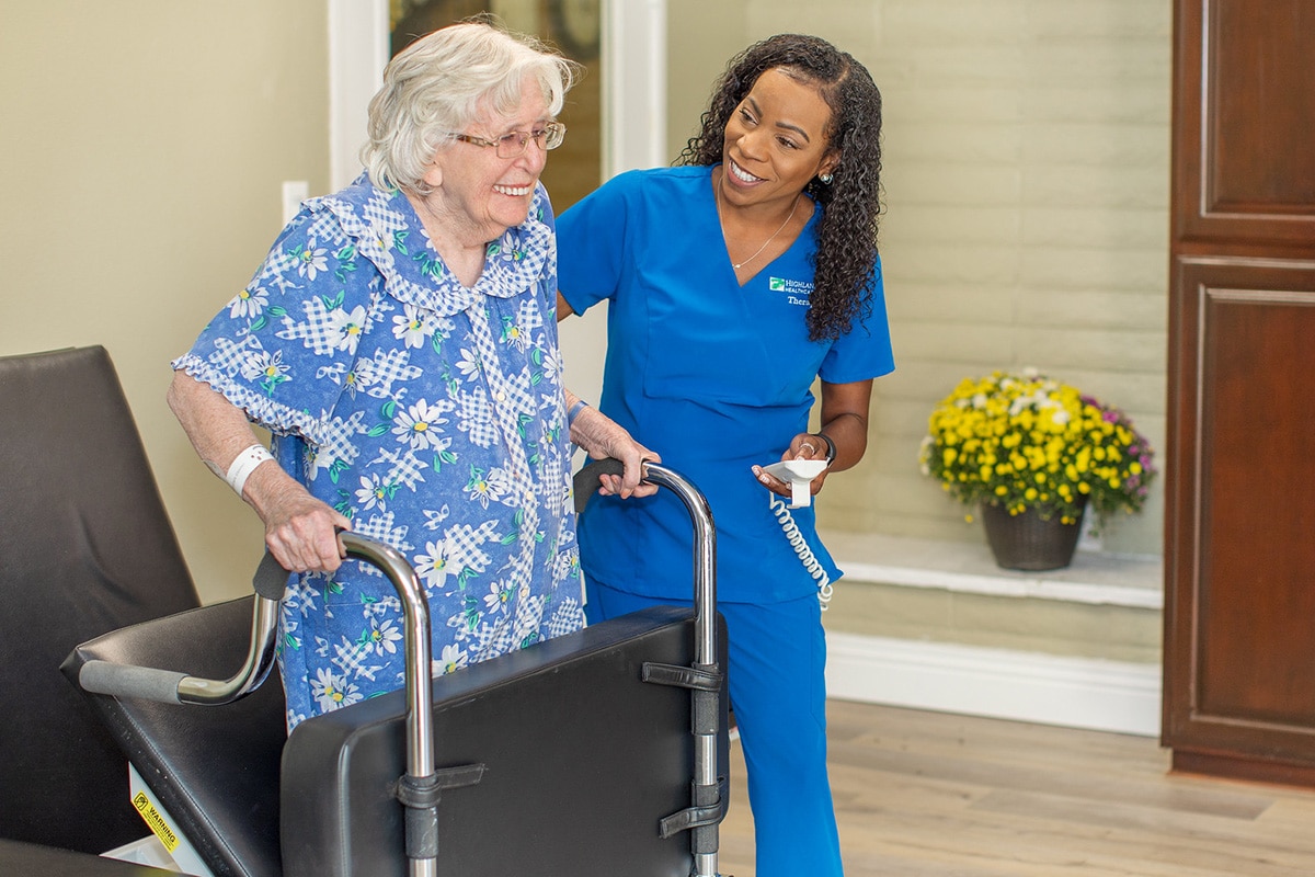Resident smiling with rehab therapist