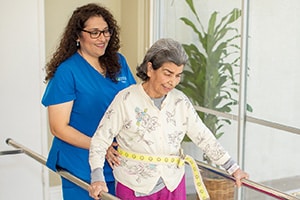 Rehab therapists assisting a senior woman